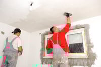 plasterers skimming a ceiling