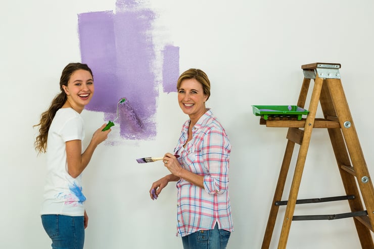 two women painting their home